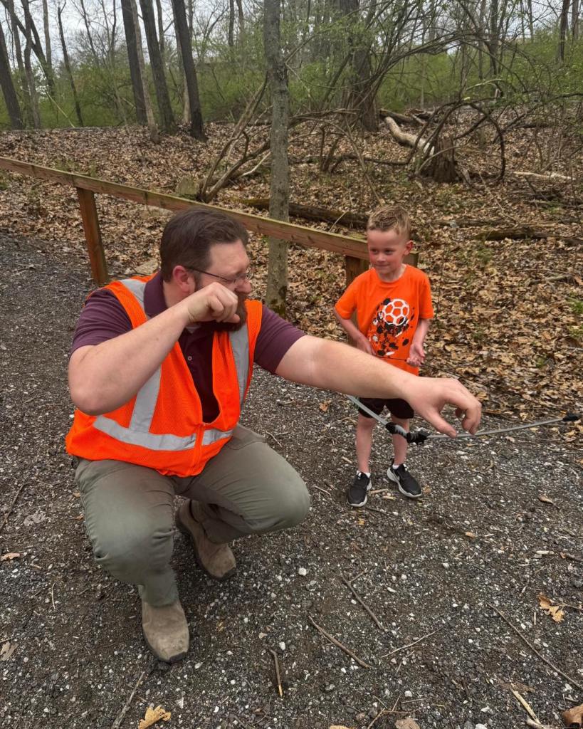 Archery instruction between a young boy and an archer